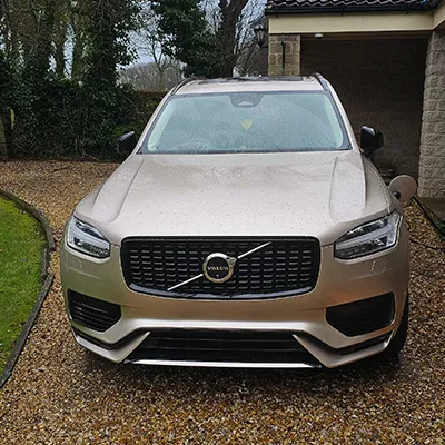 A volvo car parked in front of a house.