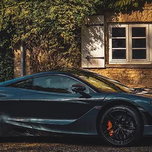 a black sports car parked in front of a building