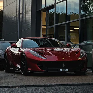 a red sports car parked in front of a building
