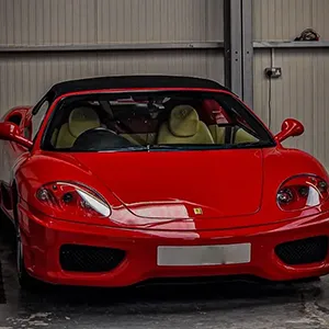 A red sports car parked in a garage.
