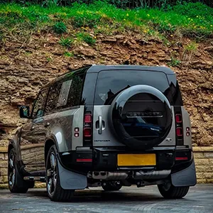 A jeep parked in front of a cliff.