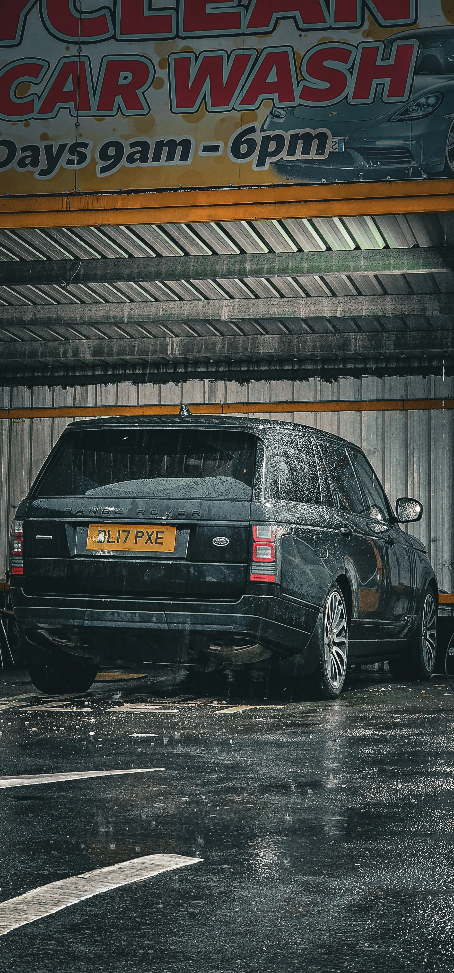 A black car parked in a parking garage.