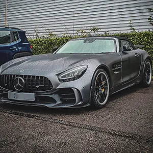 a silver mercedes sports car parked next to a blue mercedes sports car