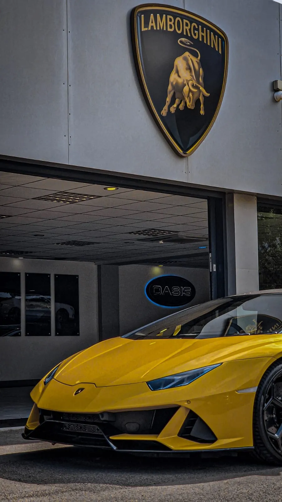 A yellow sports car parked in front of a building.