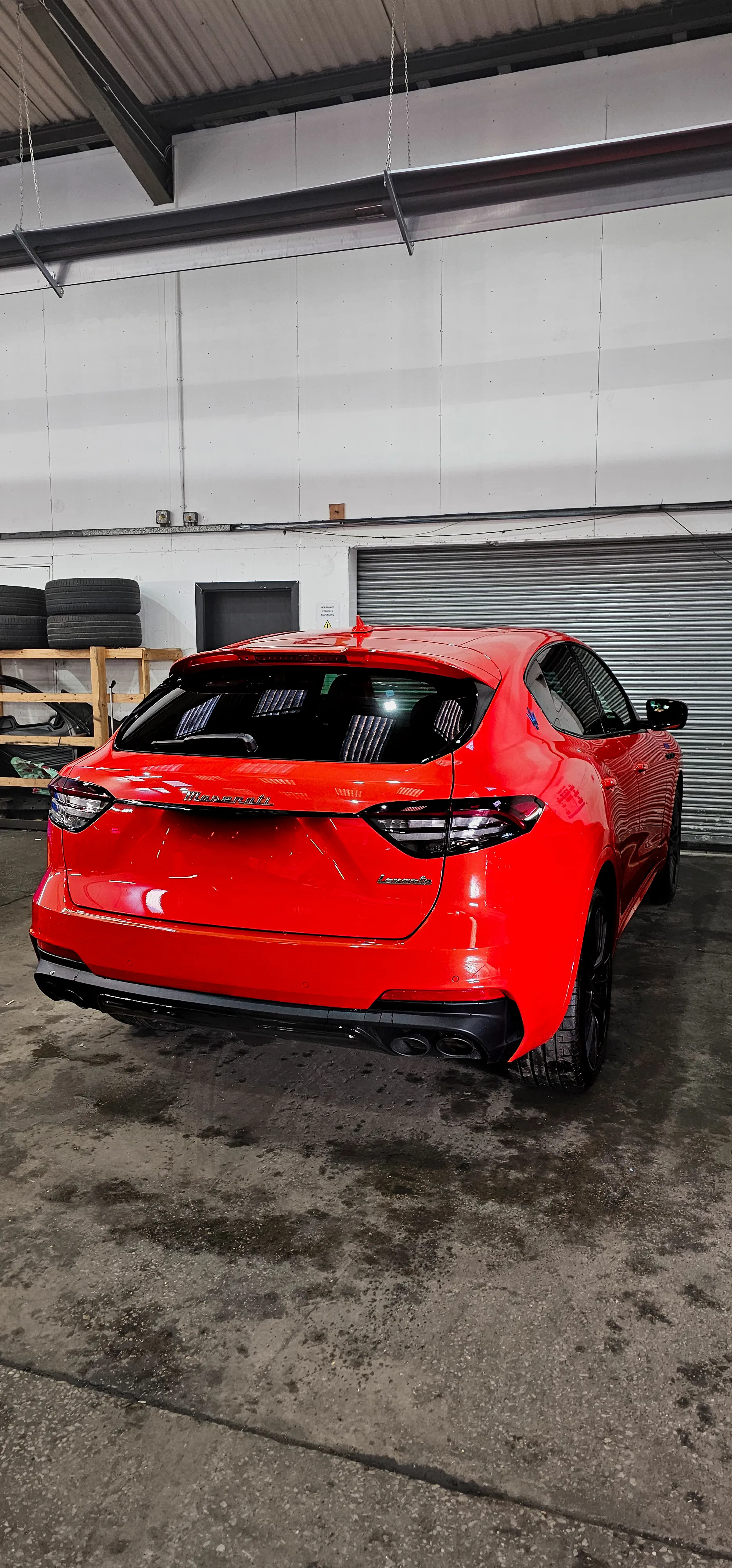 A red sports car parked in a garage.