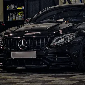 A couple of black cars parked next to each other.
