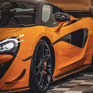 an orange sports car parked in a garage