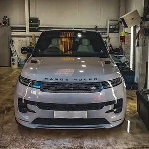 A range rover is parked in a garage.