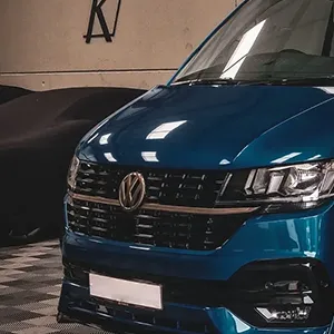 A blue volkswagen t - cross parked in a garage.