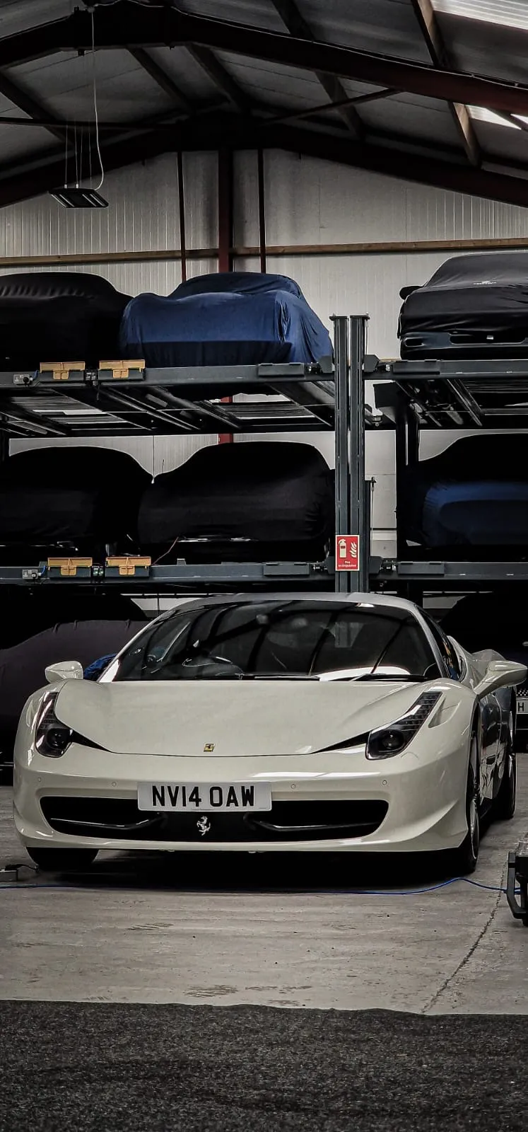 A white sports car parked in a garage.