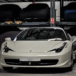 A white sports car parked in a garage.